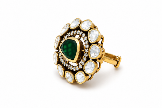 Gold-plated 925 sterling silver statement ring with pear-shaped emerald centre, Polki stones and zircon halo in traditional Indian floral design.