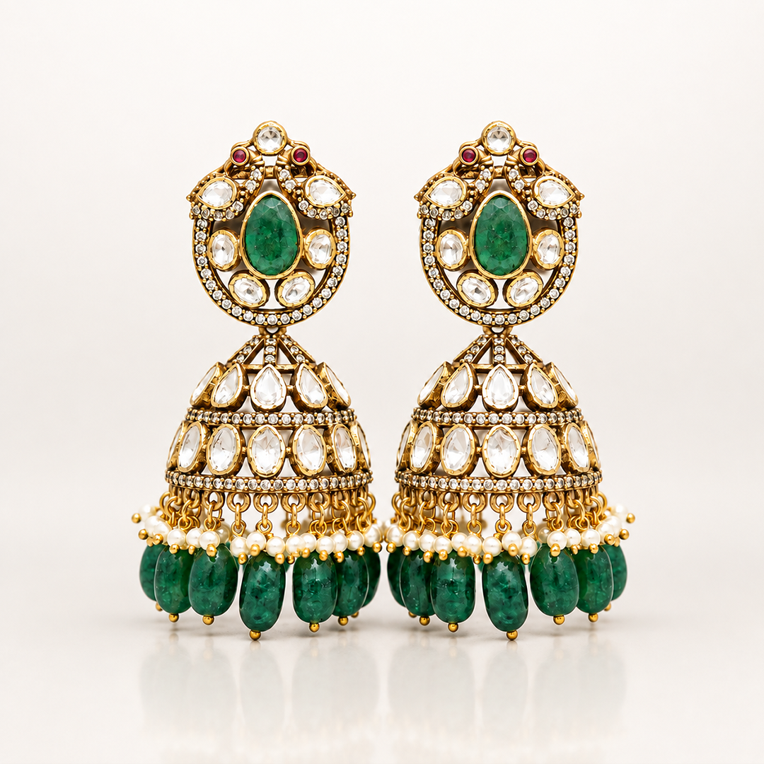 Aaranyika matching green coloured stone jhumka earrings with white stone and pearl detailing