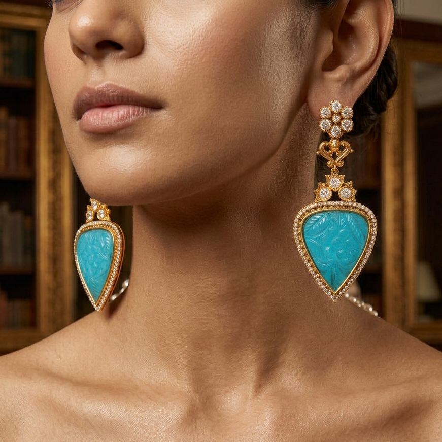 Gold-toned turquoise teardrop earrings with floral detailing