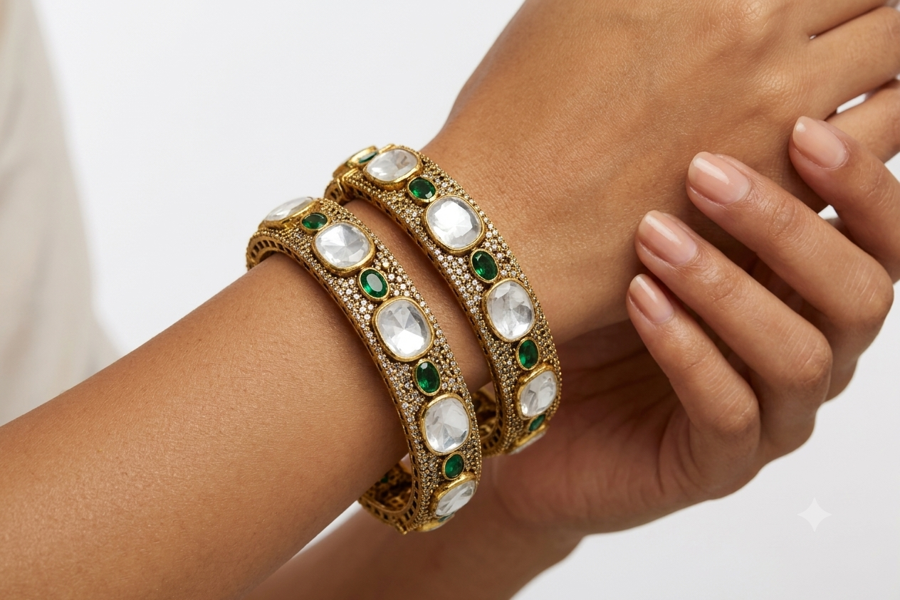 Gold plated 925 silver Rajsi Polki bangles with uncut white Polki stones, green emerald-style accents, and intricate antique craftsmanship for festive and bridal wear.