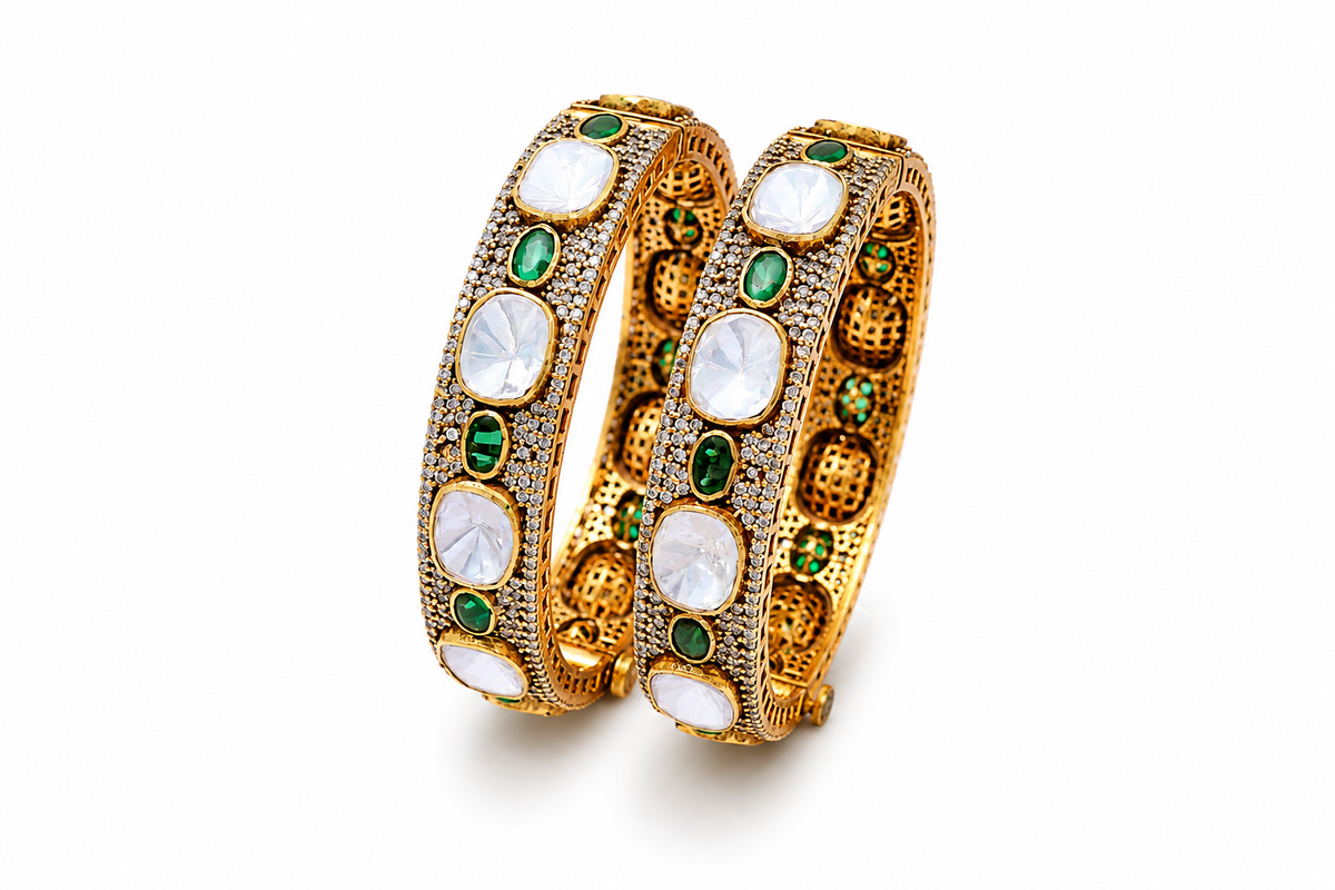 Gold plated 925 silver Rajsi Polki bangles with uncut white Polki stones, green emerald-style accents, and intricate antique craftsmanship for festive and bridal wear.