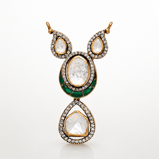 Haritara gold-toned pendant with layered teardrop design and green accents