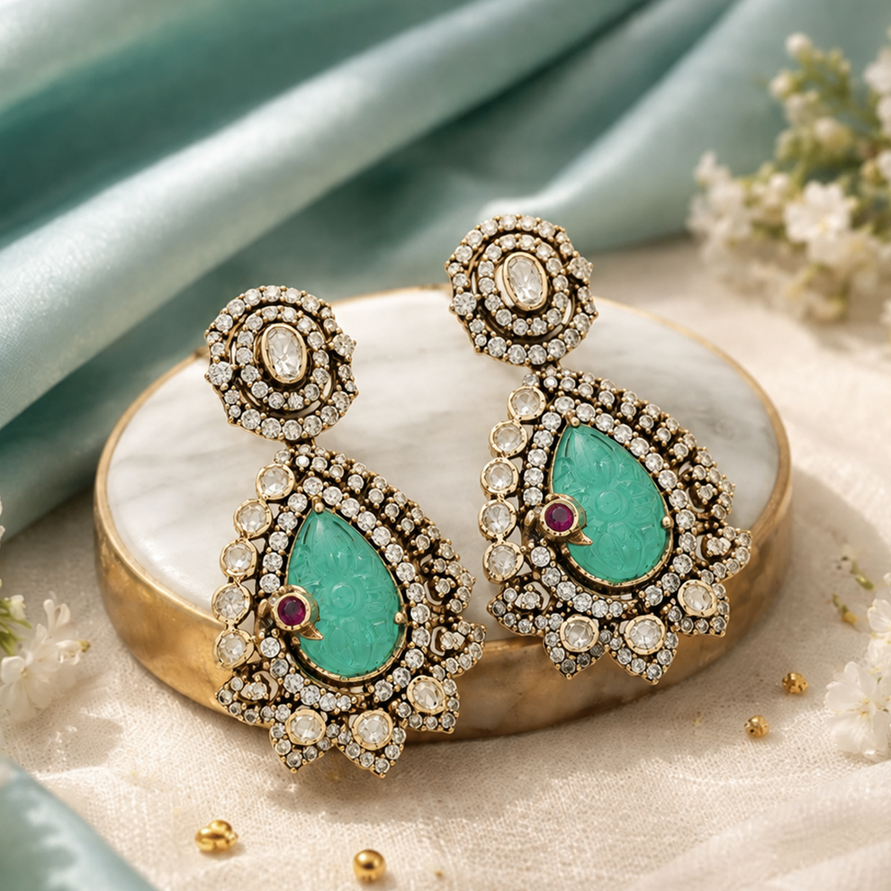 Neeraja statement earrings with aqua-green carved centre, ruby-red accent and floral detailing