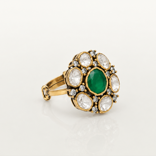 Traditional gold-plated silver ring featuring green gemstone and white stone floral detailing