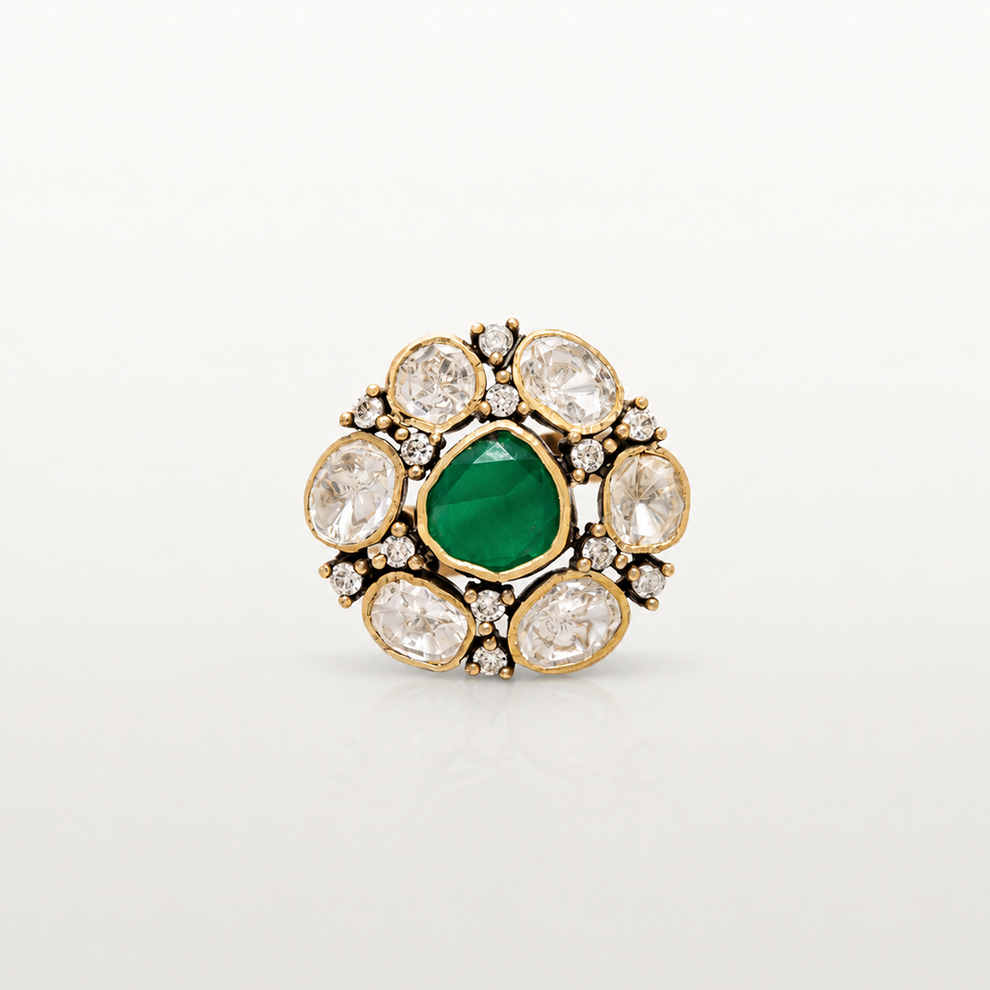 Traditional gold-plated silver ring featuring green gemstone and white stone floral detailing