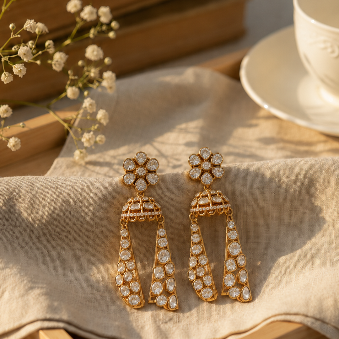 Long statement jhumka earrings with intricate gold craftsmanship