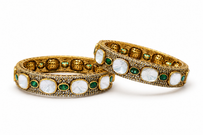 Gold plated 925 silver Rajsi Polki bangles with uncut white Polki stones, green emerald-style accents, and intricate antique craftsmanship for festive and bridal wear.