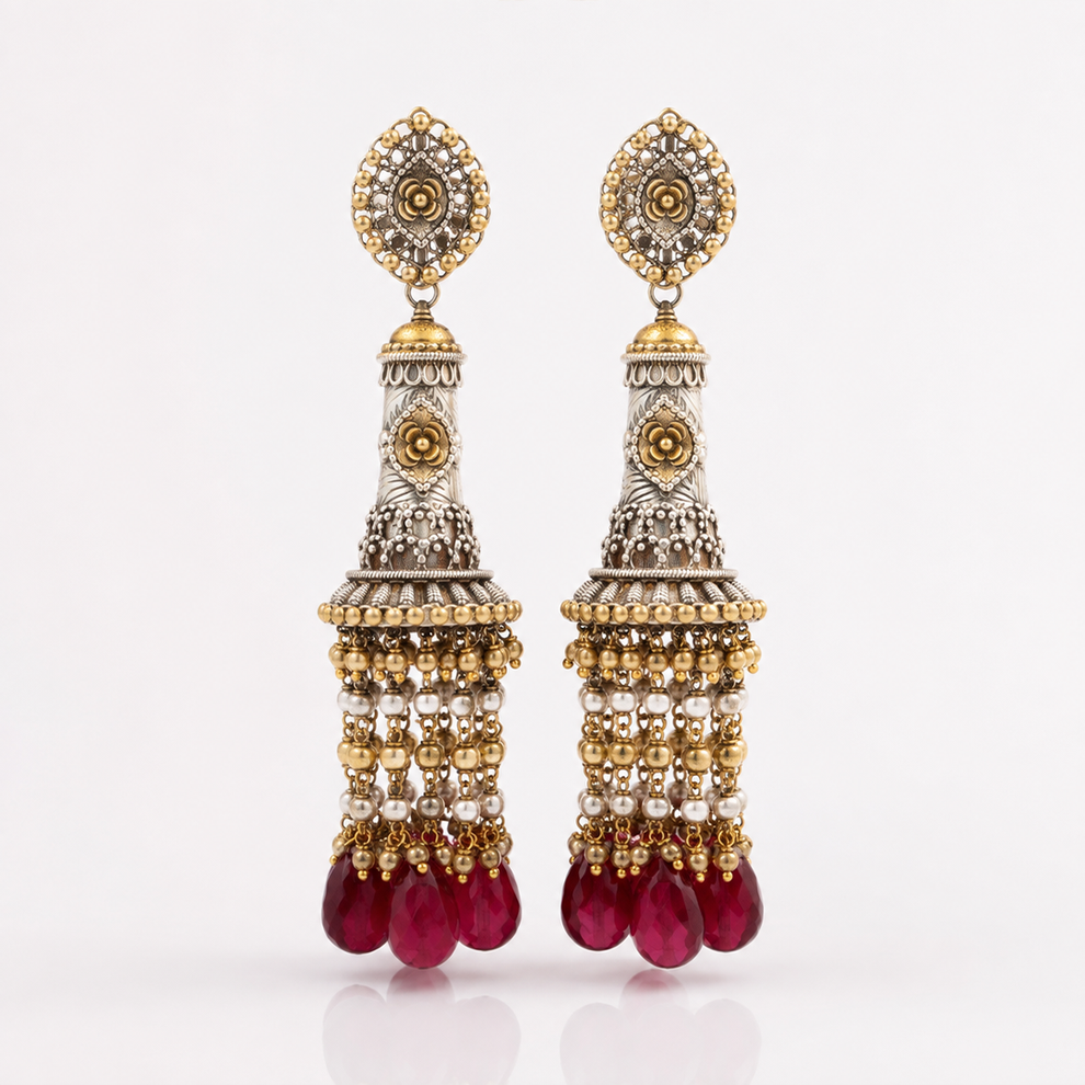 Long heritage earrings with red stone drops, pearls and intricate gold silver detailing
