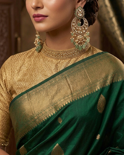 Gold-plated 925 silver crescent kundan jhumka earrings with lotus motifs, green gemstone beads, pearls, and zircon accents for festive and wedding wear