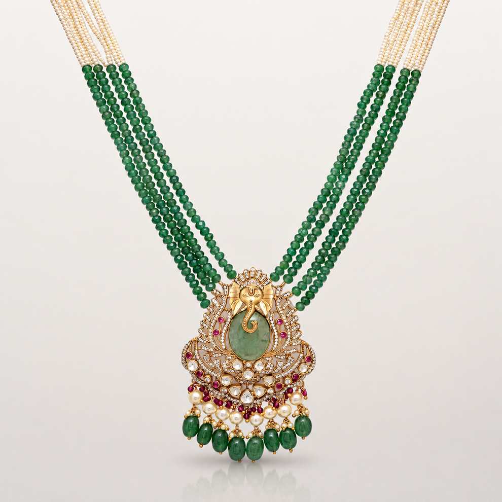 Ganesha pendant with green coloured stones and intricate gold-toned detailing